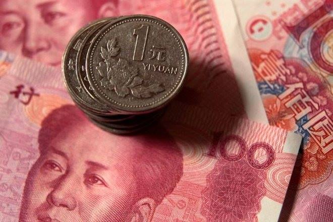 The exchange rate tumbled 1.2% to 7.0256 a dollar at 10:19 a.m. after the People’s Bank of China set its daily reference rate at a weaker level than 6.9 for the first time since December.