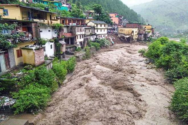 Flood water gush down after a cloudburst in Chamoli district. (PTI)