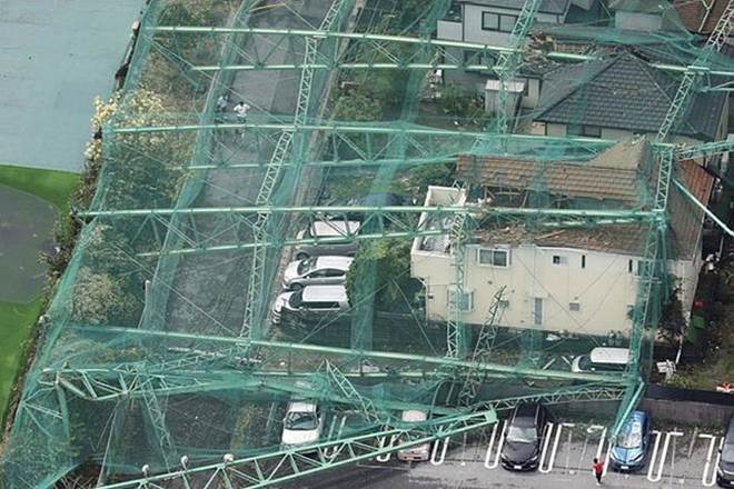 Houses and cars damaged by a collapse of the perimeter netting of a golf training field due to strong winds of Typhoon Faxai are seen in Ichihara, east of Tokyo, Japan (Reuters) Houses and cars damaged by a collapse of the perimeter netting of a golf training field due to strong winds of Typhoon Faxai are seen in Ichihara, east of Tokyo, Japan (Reuters)