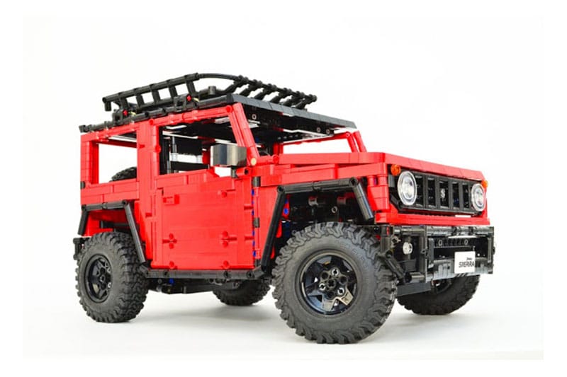 The Lego Suzuki Jimny is all-wheel drive. It even gets a rear-diff lock feature. The tyres are 1:55 DC Chequired flag all-terrain A/T. It is powered by a BuWizz brick (designed for RCs) or a Lego battery box. There are two motors for the movement of this Lego Jimny. While there is a Servo motor for the movement of the steering wheel. This Lego 4x4 can be controlled through a Smartphone with the help of a BuWizz app.