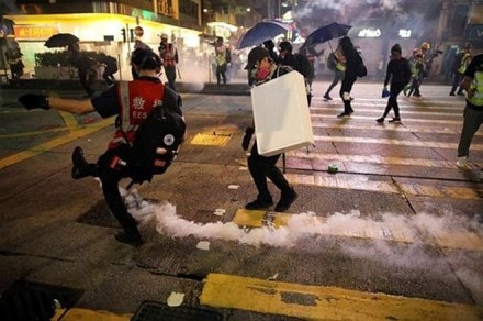 An anti-government demonstrator kick a tear gas canister during a protest in Hong Kong, China (Reuters)