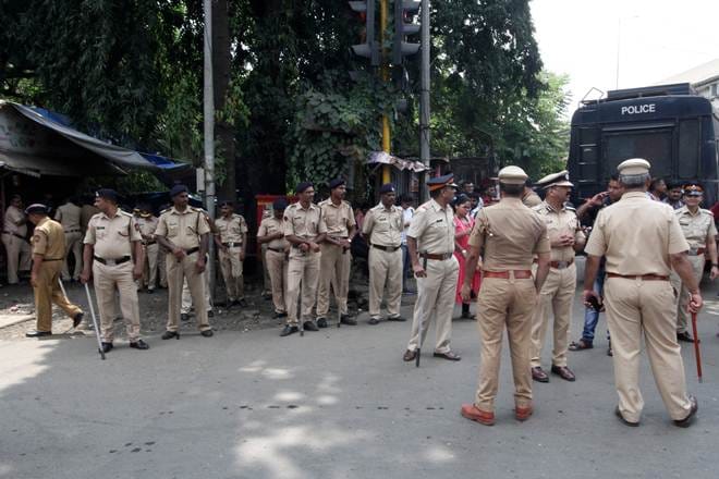 Police stand guard outside the Aarey Colony after demonstrators held a protest demanding that the Mumbai Metro Rail Corp Ltd not cut trees to build a train parking shed for an upcoming subway line, in Mumbai. (Reuters)
