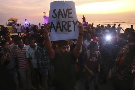 An activist holds a placard during a protest against cutting down of trees for a proposed metro car shed project at Aarey Colony in Mumbai. (AP Photo)