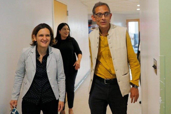 Abhijit Banerjee and Esther Duflo, two of the three winners of the 2019 Nobel Prize in Economics, arrive for a news conference at the Massachusetts Institute of Technology in Cambridge. (Reuters)