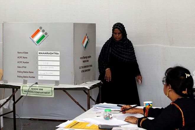 A woman leaves after casting hes vote in Mumbai. (PTI)