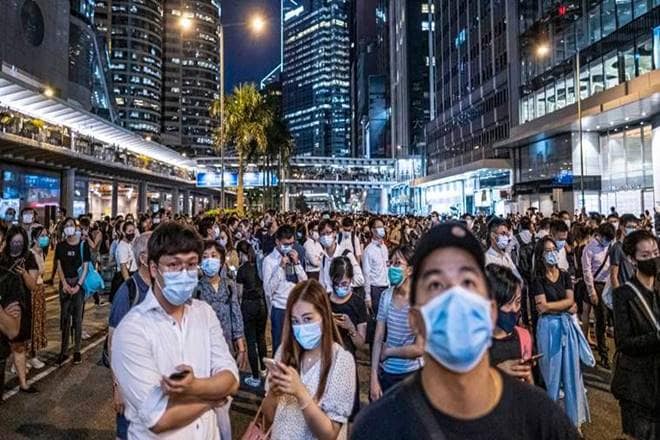 Pro-democracy district councillor Andrew Chiu, who had part of his ear bitten off in an attack at a shopping mall this month, was spotted entering a polling station in his district on Hong Kong island.