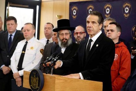New York Gov. Andrew Cuomo, right, along with police, elected officials and community leaders, speaks Sunday, Dec. 29, 2019, at Ramapo Town Hall in Ramapo, N.Y. about Saturday night's stabbings at a rabbi's home in Monsey. (Seth Harrison/The Journal News via AP) New York Gov. Andrew Cuomo, right, along with police, elected officials and community leaders, speaks Sunday, Dec. 29, 2019, at Ramapo Town Hall in Ramapo, N.Y. about Saturday night's stabbings at a rabbi's home in Monsey. (Seth Harrison/The Journal News via AP)