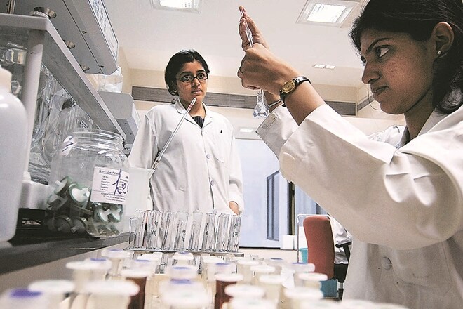 A scientist poues a chemical in a flask tube, in the lab of Sun Pharmaceuticals Industries Limited in Mumbai, India on Tuesday, May 22, 2007. Sun Pharmaceuticals Industries Limited, India's biggest drugmaker agreed to buy Taro Pharmaceuticals Industries Limited, an unprofitable producer of generic medicine, giving it factories and distribution assets in the U.S. Photograph: Abhijit Bhatlekar/Bloomberg News