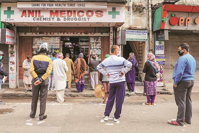 People stand outside a pharmacy to buy medicines during a nationwide lockdown, imposed in the wake of coronavirus pandemic, in Jammu (PTI photo) People stand outside a pharmacy to buy medicines during a nationwide lockdown, imposed in the wake of coronavirus pandemic, in Jammu (PTI photo)