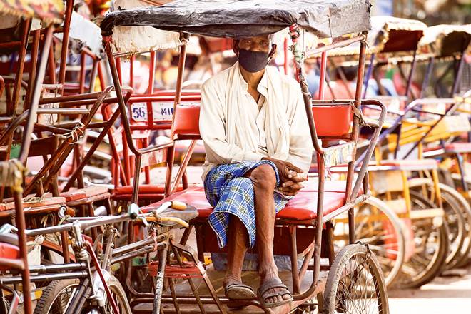 A rickshaw puller during the nationwide lockdown to curb the spread of coronavirus, in Old Delhi (PTI) A rickshaw puller during the nationwide lockdown to curb the spread of coronavirus, in Old Delhi (PTI)