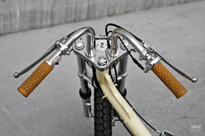 All of the original Cub bodywork is gone, except the fuel tank but it is trimmed down though, leaving just a hint of a fender at the back. Then Max shaped up a backrest for the new seat, integrating it seamlessly into the existing bodywork. It’s capped off with a gorgeous caramel-colored leather seat, which has a custom-built opening mechanism to access the gas tank. (Source: Bikeexif)