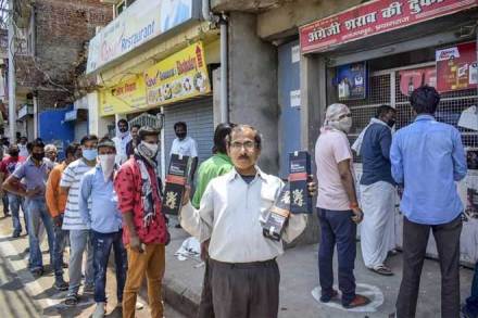 Prayagraj: People purchase alcohol from a wine shop after authorities allowed sale of liquor with certain restrictions, during the ongoing COVID-19 nationwide lockdown, in Prayagraj. (PTI Photo) Prayagraj: People purchase alcohol from a wine shop after authorities allowed sale of liquor with certain restrictions, during the ongoing COVID-19 nationwide lockdown, in Prayagraj. (PTI Photo)