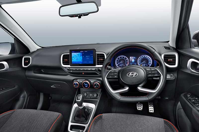 The cabin of the Hyundai Venue Sport has been reworked as well. It features a new Sport Dual Tone trim set up with denim-like fabric seats and red piping and stitching. The dash also features red accents to complement the exterior. The HVAC knobs, the ac vents and the stitching of the leather-wrapped steering wheel in red add to the sporty flavour that Hyundai is going for. Additionally, the Venue now gets a new multi-function flat-bottom steering wheel which matches the design in its latest generation models like the new Creta.