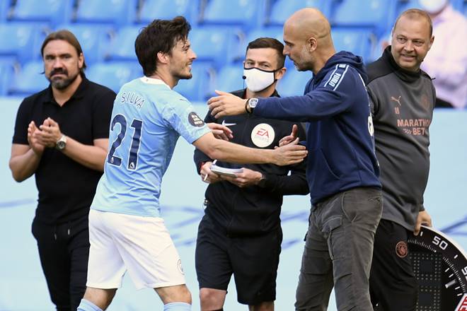 Manchester City's David Silva gets a hug from Manchester City's head coach Pep Guardiola as he leaves the pitch at the end of the English Premier League soccer match between Manchester City and Norwich City at the Etihad Stadium in Manchester, England, Sunday, July 26, 2020. (Peter Powelll/Pool via AP) Manchester City's David Silva gets a hug from Manchester City's head coach Pep Guardiola as he leaves the pitch at the end of the English Premier League soccer match between Manchester City and Norwich City at the Etihad Stadium in Manchester, England, Sunday, July 26, 2020. (Peter Powelll/Pool via AP)