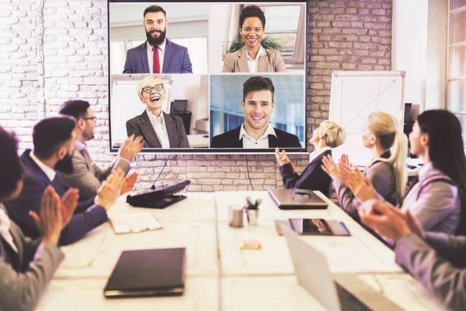 Business people looking at a screen during a video conference in the conference room