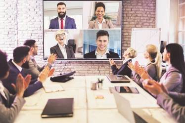 Business people looking at a screen during a video conference in the conference room