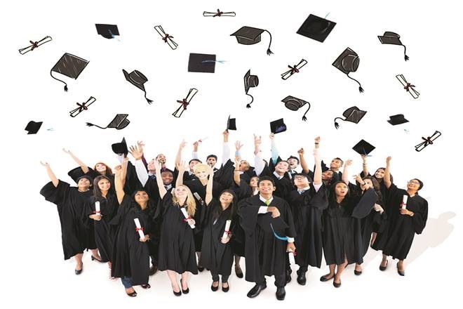Graduates throwing their graduation caps.