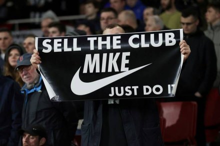 FILE PHOTO: Soccer Football - Premier League - Arsenal v Newcastle United - Emirates Stadium, London, Britain - February 16, 2020 A fan displays a banner in reference to Newcastle United owner Mike Ashley during the match REUTERS/Eddie Keogh EDITORIAL USE ONLY. No use with unauthorized audio, video, data, fixture lists, club/league logos or "live" services. Online in-match use limited to 75 images, no video emulation. No use in betting, games or single club/league/player publications. Please contact your account representative for further details./File Photo
