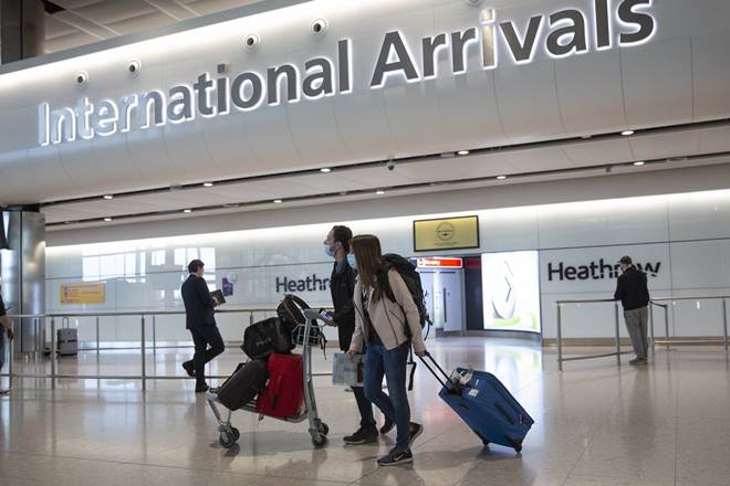 London: Passengers wearing face masks arrive on the first day of new rules that people arriving in Britain from overseas will have to quarantine themselves for 14 days to help stop the spread of coronavirus, at Heathrow Airport in London, Monday, June 8, 2020. The British government has said that anyone caught not complying with the quarantine will face a fine. AP/PTI(AP08-06-2020_000208A) London: Passengers wearing face masks arrive on the first day of new rules that people arriving in Britain from overseas will have to quarantine themselves for 14 days to help stop the spread of coronavirus, at Heathrow Airport in London, Monday, June 8, 2020. The British government has said that anyone caught not complying with the quarantine will face a fine. AP/PTI(AP08-06-2020_000208A)