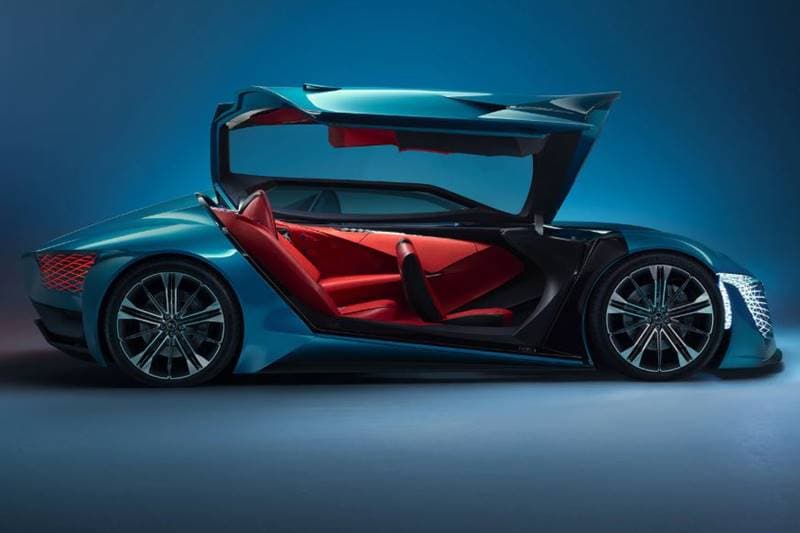 The chassis is built from carbon fibre for super lightness. The driver's side gets a scissor door, while the passenger side gets a double-length gullwing door. The exterior is unlike anything we've seen before. The front and tail lights are stunning, "light veil" curtains stretch across the asymmetrical front and rear aspects of the car.