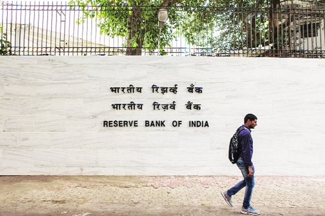 A pedestrian walks past the RBI building in Mumbai. Some of Acharya’s hard-hitting speeches provide a glimpse of the wide chasm between Mint Street and Delhi during his stint as deputy governor of RBI between January 2017 and July 2019 (Bloomberg image)