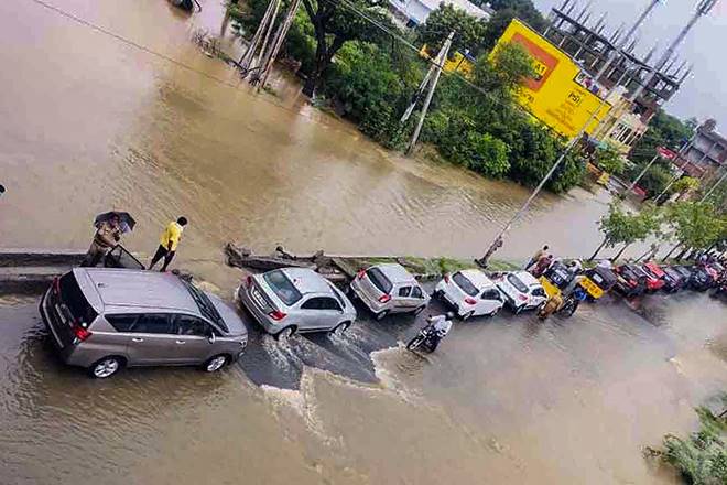 Warangal: Vehicles ply on a flooded road after heavy overnight rains, in Warangal district, Saturday, Aug 15, 2020. (PTI Photo) (PTI15-08-2020_000325B)