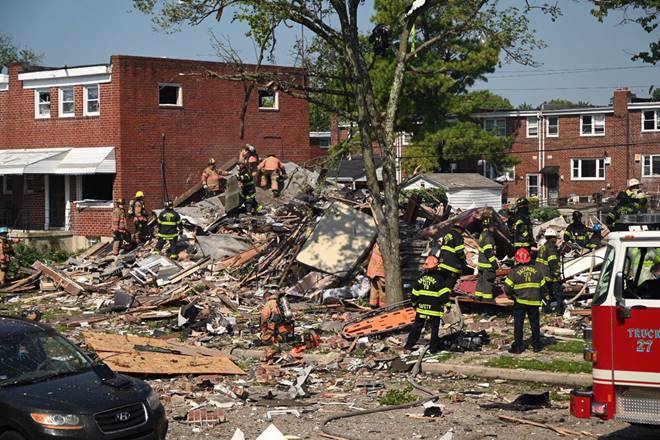 Firefighters at the scene of where homes are destroyed Monday, August 10, 2020 at Boxhill Road and Reisterstown Road in Northeast Baltimore. A natural gas explosion has completely destroyed three row houses in Baltimore, killing at least one person and critically injuring several others. (Jerry Jackson/The Baltimore Sun via AP)