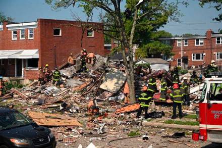 Firefighters at the scene of where homes are destroyed Monday, August 10, 2020 at Boxhill Road and Reisterstown Road in Northeast Baltimore. A natural gas explosion has completely destroyed three row houses in Baltimore, killing at least one person and critically injuring several others. (Jerry Jackson/The Baltimore Sun via AP) Firefighters at the scene of where homes are destroyed Monday, August 10, 2020 at Boxhill Road and Reisterstown Road in Northeast Baltimore. A natural gas explosion has completely destroyed three row houses in Baltimore, killing at least one person and critically injuring several others. (Jerry Jackson/The Baltimore Sun via AP)