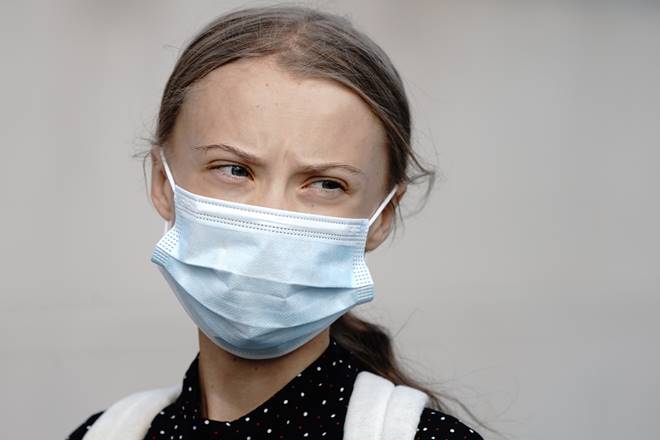Climate activists Greta Thunberg wears a face mask as she arrives for a meeting with German Chancellor Angela Merkel at the chancellery in Berlin, Germany, Thursday, Aug. 20, 2020. (Kay Nietfeld/dpa via AP)