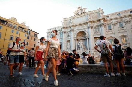 FILE PHOTO: People wearing face masks walk in front of the Trevi Fountain following a government decree that states face coverings must be worn between 6 p.m. and 6 a.m. near bars and pubs and in areas where gatherings are more likely, due to the coronavirus disease (COVID-19) outbreak, in Rome, Italy August 19, 2020. REUTERS/Guglielmo Mangiapane/File Photo FILE PHOTO: People wearing face masks walk in front of the Trevi Fountain following a government decree that states face coverings must be worn between 6 p.m. and 6 a.m. near bars and pubs and in areas where gatherings are more likely, due to the coronavirus disease (COVID-19) outbreak, in Rome, Italy August 19, 2020. REUTERS/Guglielmo Mangiapane/File Photo