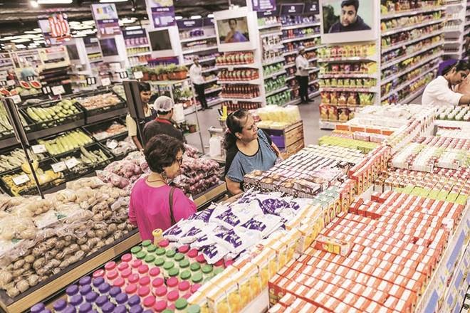 Customers browse groceries at a Big Bazaar hypermarket, operated by Future Retail Ltd., in Mumbai, India, on Sunday, April 16, 2017. Future Retail, India's biggest department store chain, still has room to extend the rally that's more than doubled its market value this year. A shortage of cash hit purchases of soaps to cars after Prime Minister Narendra Modi in November junked high-value currency bills, driving shoppers to large-format stores like Future Retail that accept credit cards. Photographer: Dhiraj Singh/Bloomberg