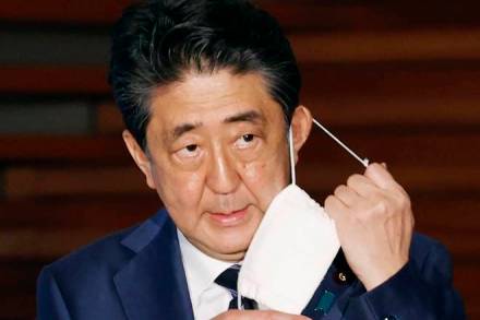 FILE - In this May 21, 2020, file photo, Japan's Prime Minister Shinzo Abe removes a face mask as he speaks at a press conference in Tokyo. Prime Minister Abe on Monday became Japan's longest-serving leader in terms of consecutive days in office, but there was little fanfare, as he visited a hospital for another health checkup amid concerns about his health. (Kyodo News via AP, File) FILE - In this May 21, 2020, file photo, Japan's Prime Minister Shinzo Abe removes a face mask as he speaks at a press conference in Tokyo. Prime Minister Abe on Monday became Japan's longest-serving leader in terms of consecutive days in office, but there was little fanfare, as he visited a hospital for another health checkup amid concerns about his health. (Kyodo News via AP, File)