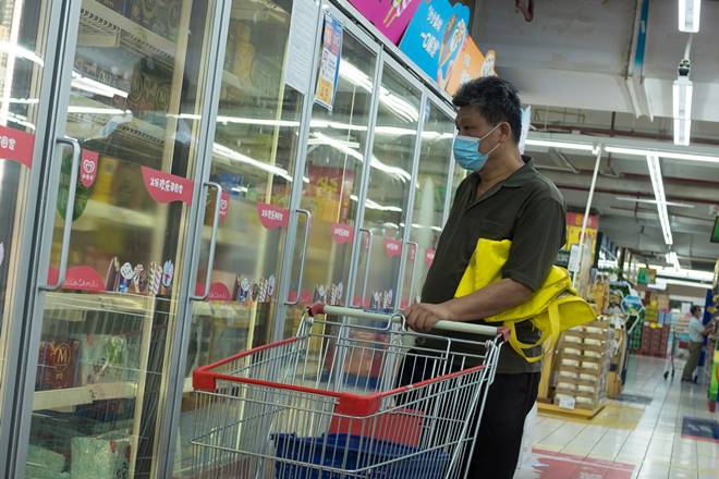A man looks at frozen food products in a supermarket following an outbreak of the coronavirus disease (COVID-19) in Beijing, China, August 13, 2020. REUTERS/Thomas Peter