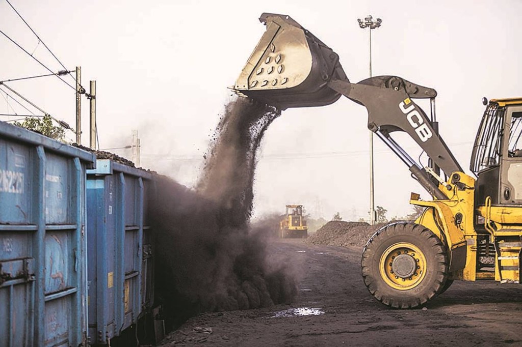 A JC Bamford Excavators Ltd. (JCB) front loader loads coal onto a freight wagon at the Tori Siding on the Tori-Shivpur rail line, operated by Indian Railways and funded by Coal India Ltd., in Chandwa, Jharkhand, India, on Thursday, May 17, 2018. State miner Coal India's output and shipments jumped to seasonal records in June, buoyed by summer demand from power stations, the company's biggest customers. Photographer: Prashanth Vishwanathan/Bloomberg