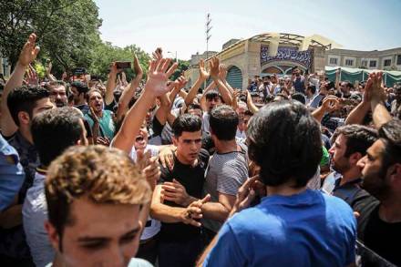FILE - In this June 25, 2018 file photo, a group of protesters chant slogans at the main gate of the Old Grand Bazaar, in Tehran, Iran. On Saturday, Sept. 5, 2020, Iran broadcast the televised confession of a wrestler facing the death penalty after a tweet from President Donald Trump criticizing the case, a segment that resembled hundreds of other suspected coerced confessions aired over the last decade in the Islamic Republic. The case of 27-year-old Navid Afkari has drawn the attention of a social media campaign that portrays him and his brothers as victims targeted over participating in protests against Iran's Shiite theocracy in 2018. (Iranian Labor News Agency via AP, File) FILE - In this June 25, 2018 file photo, a group of protesters chant slogans at the main gate of the Old Grand Bazaar, in Tehran, Iran. On Saturday, Sept. 5, 2020, Iran broadcast the televised confession of a wrestler facing the death penalty after a tweet from President Donald Trump criticizing the case, a segment that resembled hundreds of other suspected coerced confessions aired over the last decade in the Islamic Republic. The case of 27-year-old Navid Afkari has drawn the attention of a social media campaign that portrays him and his brothers as victims targeted over participating in protests against Iran's Shiite theocracy in 2018. (Iranian Labor News Agency via AP, File)