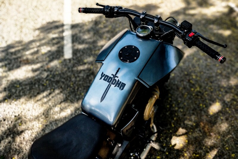 Another key highlight is a massive 200 section rear tyre. The rear suspension has also been upgraded with a monoshock unit. The straight handlebar is custom-built and it gets a digital instrument cluster. With its raw and tough appeal finished in grey, you can almost see a knight riding it (well, his shield is already on it).