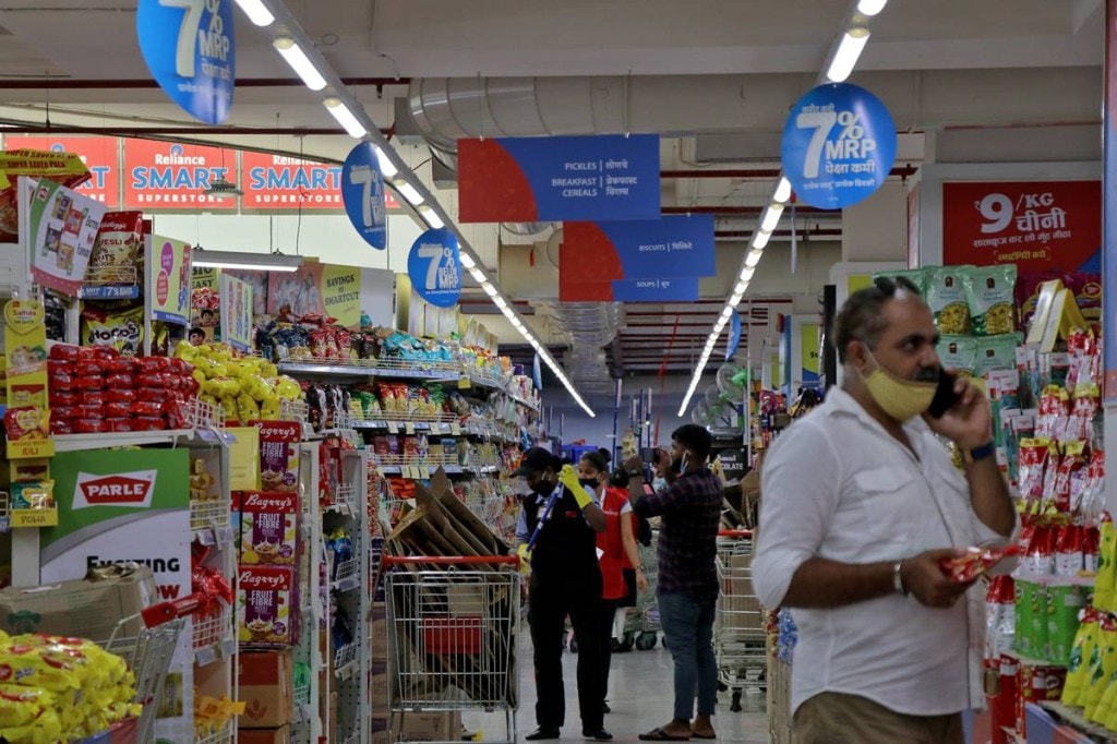Customers buy grocery items inside a superstore of Reliance Industries Ltd, in Mumbai. (Reuters image) Customers buy grocery items inside a superstore of Reliance Industries Ltd, in Mumbai. (Reuters image)