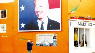 A woman takes a picture of a mural of US Presidential candidate Joe Biden in Ballina, west of Ireland. Ballina is the ancestral home of Joe Biden (AP photo)