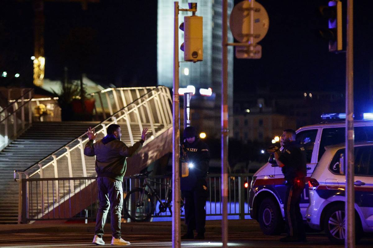 Police officers check a person on a street after exchanges of gunfire in Vienna, Austria. (Reuters image) Police officers check a person on a street after exchanges of gunfire in Vienna, Austria. (Reuters image)