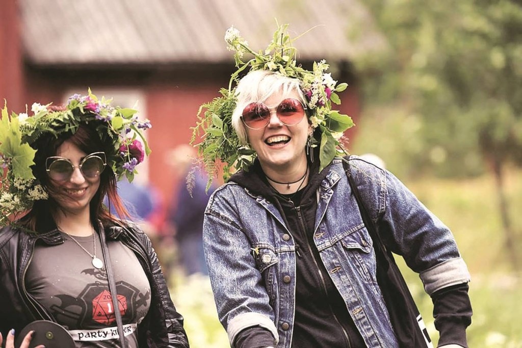 A file photo of people celebrating Midsummer Eve Festival in Helsinki, Finland. The 2020 World Happiness Report ranked Finland as number one among 153 countries in global happiness rankings for the third year in a row (Credit: Reuters)