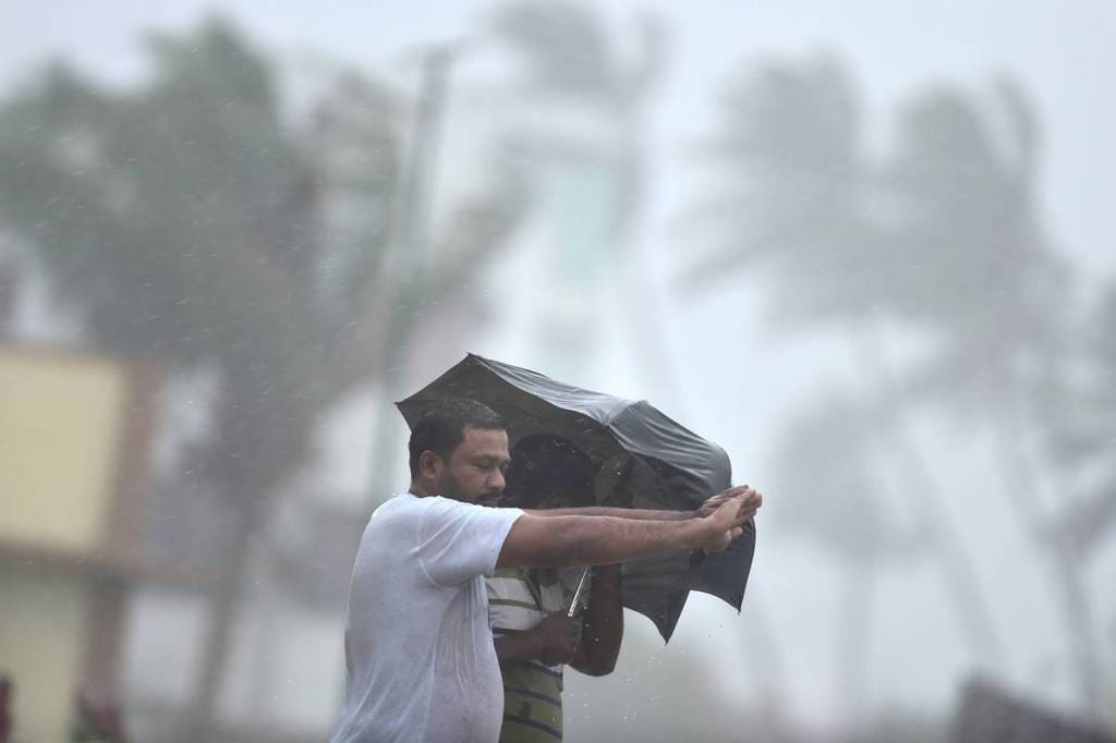 People walk on a street during rain due to Cyclone Nivar, in Chengalpattu district. (PTI Photo)