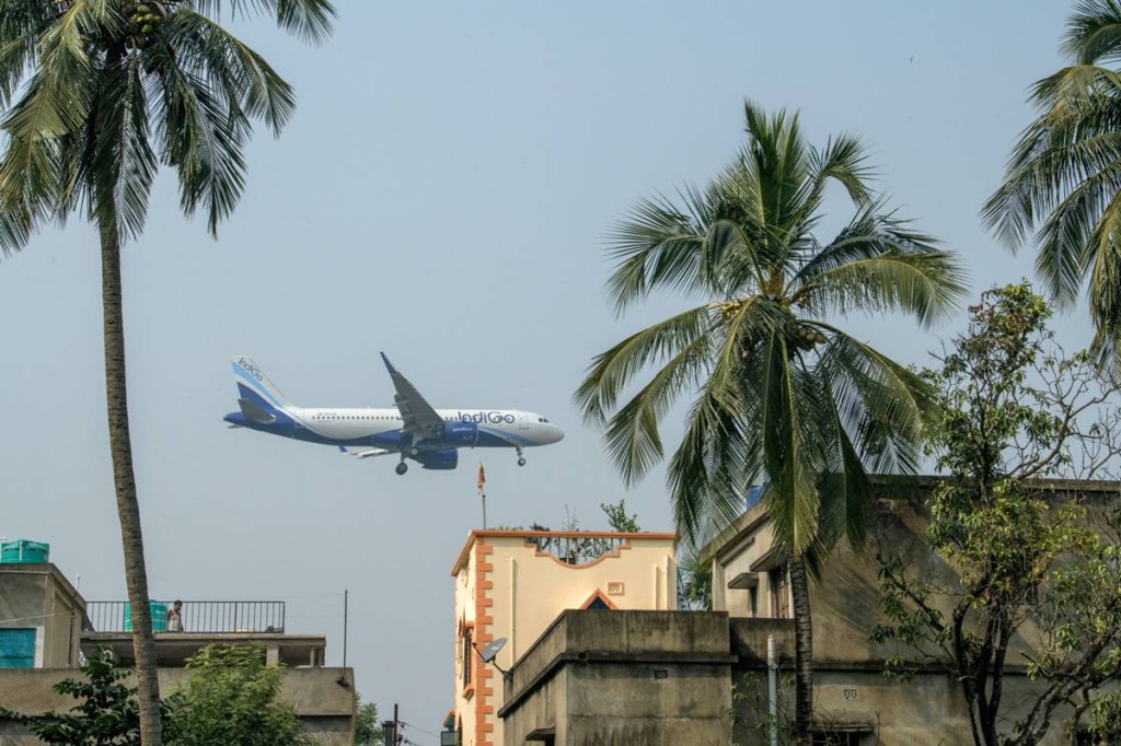 An aircraft operated by IndiGo, a unit of InterGlobe Aviation Ltd., prepares to land at Netaji Subhas Chandra Bose International Airport in Kolkata, India, on Sunday, Dec. 6, 2020. The pandemic continues to destroy global aviation, with countries closing borders, companies slashing travel budgets and tourists deferring trips indefinitely. (Credit: Photographer: Arko Datto/Bloomberg) An aircraft operated by IndiGo, a unit of InterGlobe Aviation Ltd., prepares to land at Netaji Subhas Chandra Bose International Airport in Kolkata, India, on Sunday, Dec. 6, 2020. The pandemic continues to destroy global aviation, with countries closing borders, companies slashing travel budgets and tourists deferring trips indefinitely. (Credit: Photographer: Arko Datto/Bloomberg)