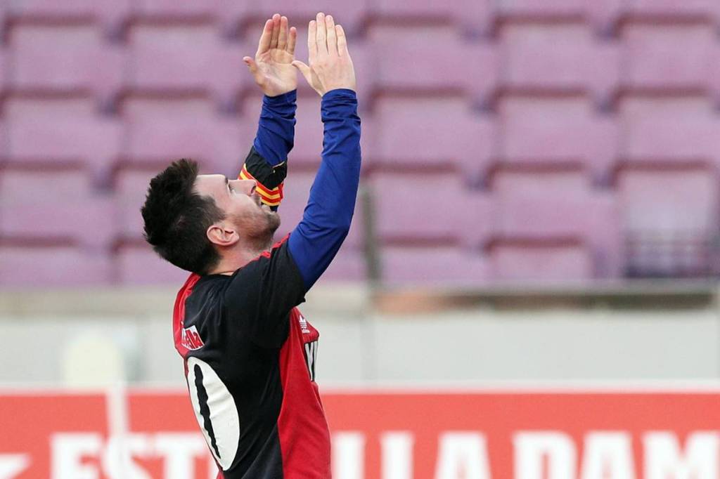 FC Barcelona's Lionel Messi celebrates scoring their fourth goal wearing a Newell's Old Boys shirt in reference to former player Diego Maradona. (Reuters image)