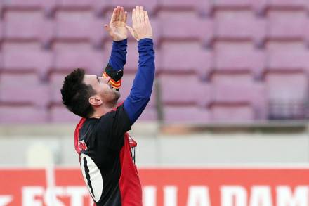 FC Barcelona's Lionel Messi celebrates scoring their fourth goal wearing a Newell's Old Boys shirt in reference to former player Diego Maradona. (Reuters image)