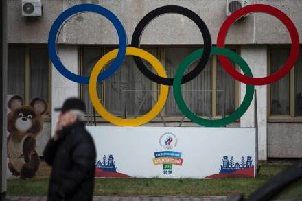 Olympic Rings and a model of Misha the Bear Cub, the mascot of the Moscow 1980 Olympic Games are seen in the yard of Russian Olympic Committee building in Moscow, Russia. (AP Photo/file)