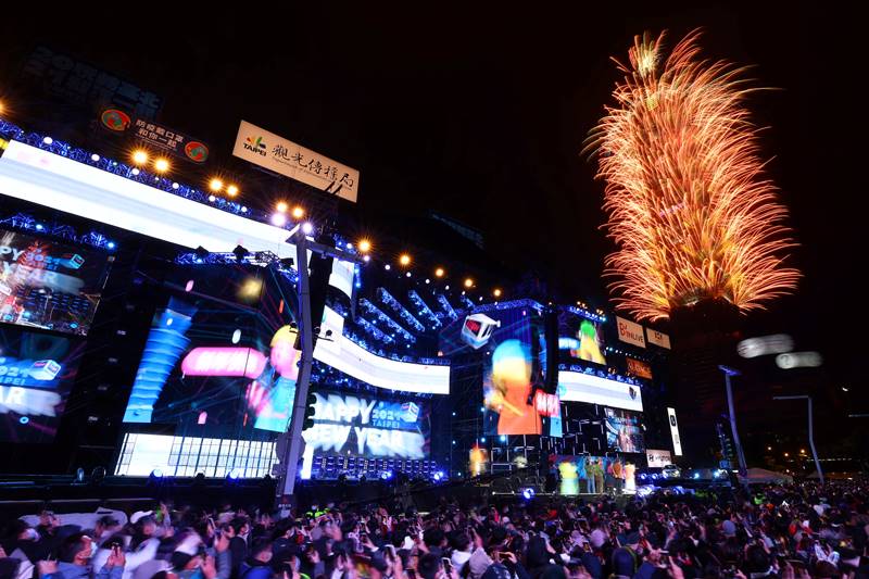 The crowd watch as fireworks explode from the landmark building Taipei 101 during New Year celebrations in Taipei Taiwan