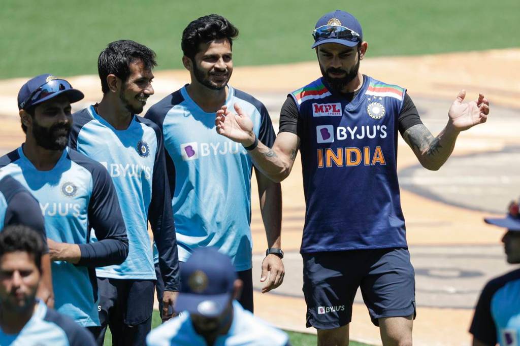 Indian captain Virat Kohli, right, gestures as he talks with teammates on the field ahead of the one day international cricket match between India and Australia at the Sydney Cricket Ground in Sydney, Australia. (AP Photo)