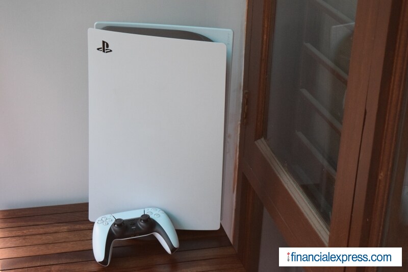 The PlayStation 5 has a dual-tone design with a white and black colour scheme. The exterior is white (and a bit curvy) while the middle portion is black (and glossy). Sony likes to show off its consoles standing tall and all that, but you will be able to prop it up horizontally too. Some manual assembly is required to set it up. Sony ships a base stand in the box that attaches to the PS5 in either orientation. Vertically, the PS5 looks like a skyscraper from a big budget sci-fi movie. The console has already visited meme-city on Twitter where it has been compared with everything from a router to Sauron's tower. Regardless, it is big -- in fact, one of the biggest consoles ever -- and isn't shy about it either. (Photo credit: Saurabh Singh/Financial Express)