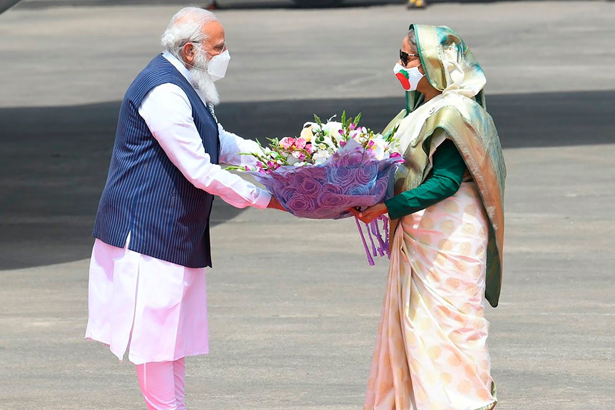 India Prime Minister Narendra Modi receives bouquet from Bangladesh PM Sheikh Hasina in Dhaka