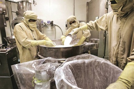Workers pour in raw material to product medicine capsules at Dr Reddy's plant in Bachupally, Andra Pradesh state, India, Thursday, April 6, 2006. Ranbaxy Laboratories Ltd., India's largest drugmaker, and Dr. Reddy's Laboratories Ltd., the third biggest, say they plan to make acquisitions in the U.S. and Europe. Photographer: Amit Bhargava/Bloomberg News